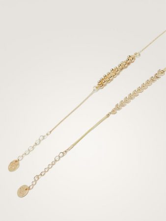 Pulseras flecha y bolita de Massimo Dutti 