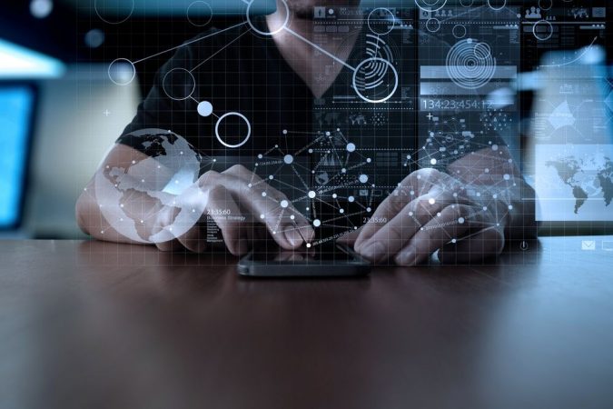 Businessman hand using mobile phone with digital layer effect as business strategy concept Merca2.es