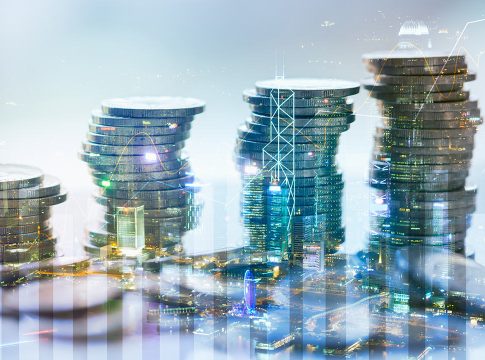 Double exposure of city with graph and stack of coins for finance and business concept