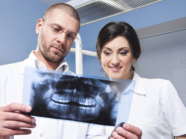 Dentistas revisan radiografía dental