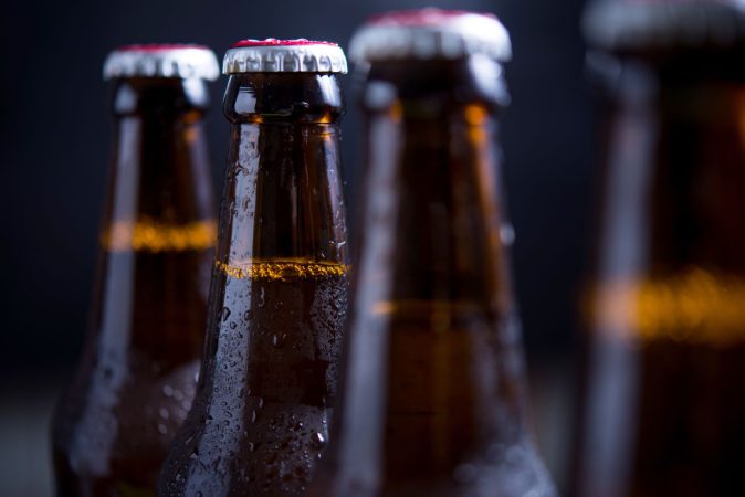 glass bottles beer with glass ice dark background Merca2.es