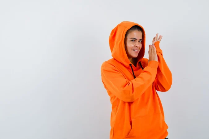 Con este chubasquero de Decathlon no pierdes estilo y no necesitas llevar paraguas 11 Merca2.es female orange hoodie posing while standing looking alluring Merca2.es