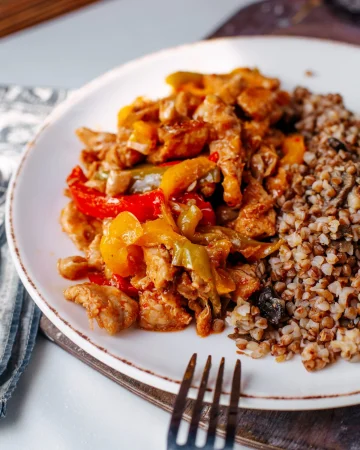 front view fried chicken sliced along with buckwheat inside white plate light floor Merca2.es