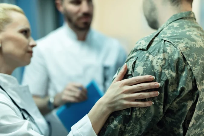 primer plano de un soldado del ejercito siendo consolado mientras habla con los medicos en la clinica Merca2.es