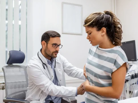 patient-telling-physician-about-her-pain-health-problems-visit-hospital-young-woman-complaining-about-back-kidney-ache-while-sitting-examination-bed-doctor-s-office