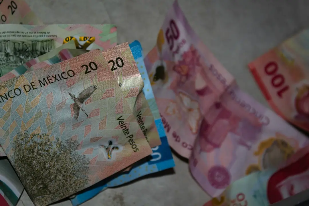 A pile of money sitting on top of a table
