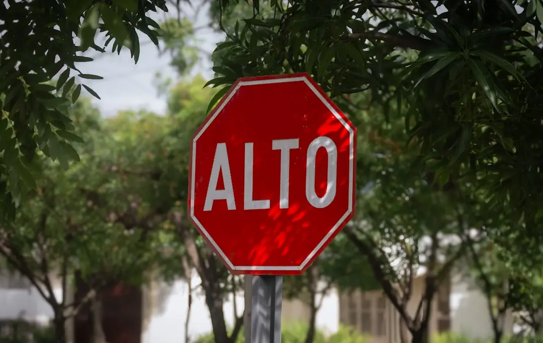 A stop sign with the word alto painted on it