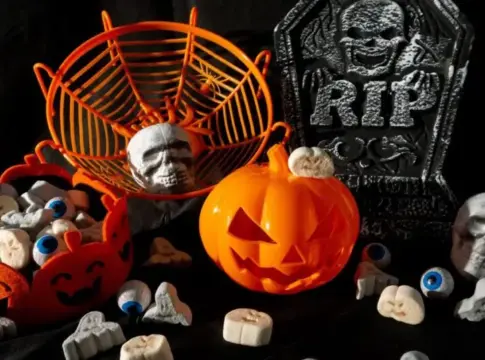 Adornos de Halloween con calabaza y calaveras Decoración de Halloween con calabaza naranja, calaveras, ojos y lápidas sobre fondo oscuro