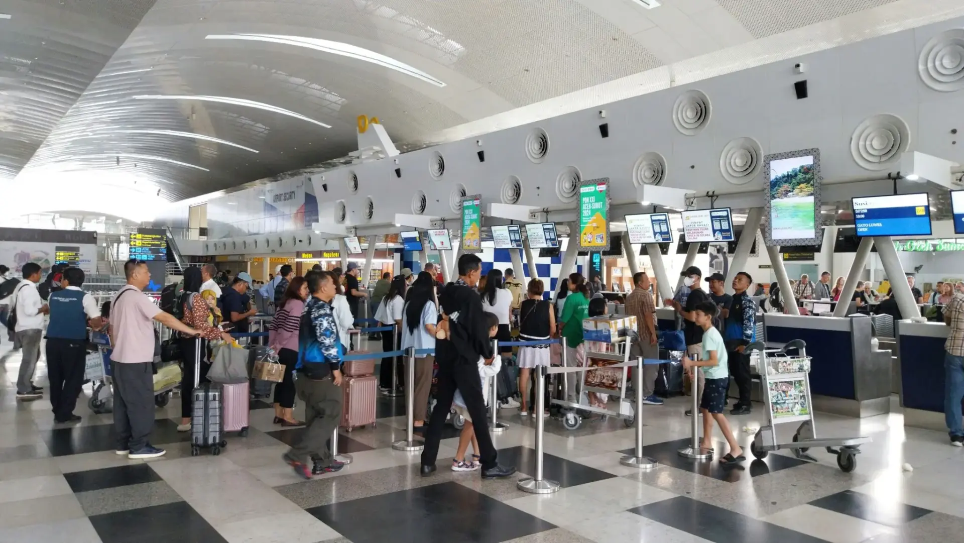Filas de pasajeros en mostradores de aeropuerto Ryanair facturación equipaje