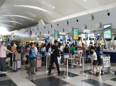 Filas de pasajeros en mostradores de aeropuerto Ryanair facturación equipaje
