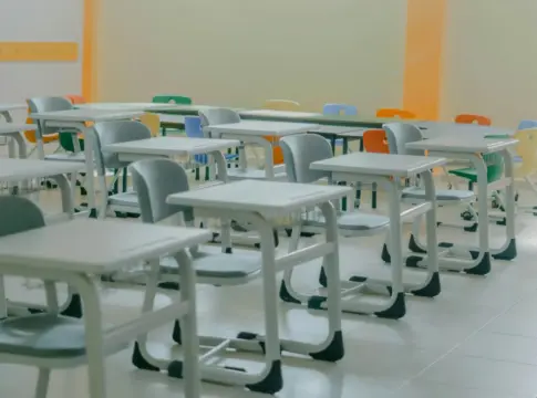 Aula vacía con pupitres y sillas oposiciones Sergas