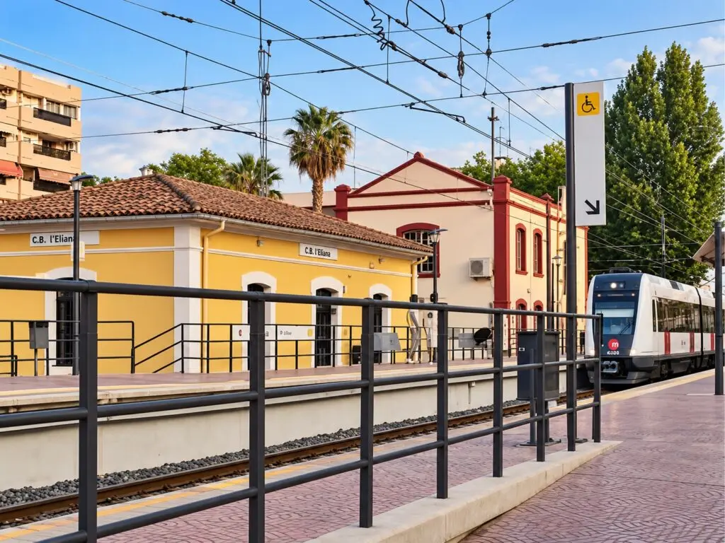 Estación de Metrovalencia en l’Eliana, con un tren junto al andén y vías.