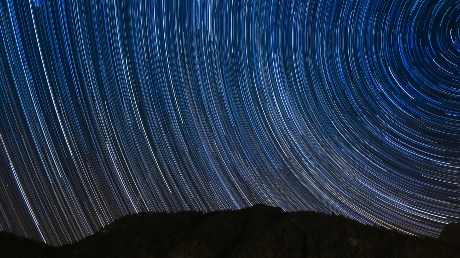 Estelas estelares sobre una montaña oscura primera estrella verde