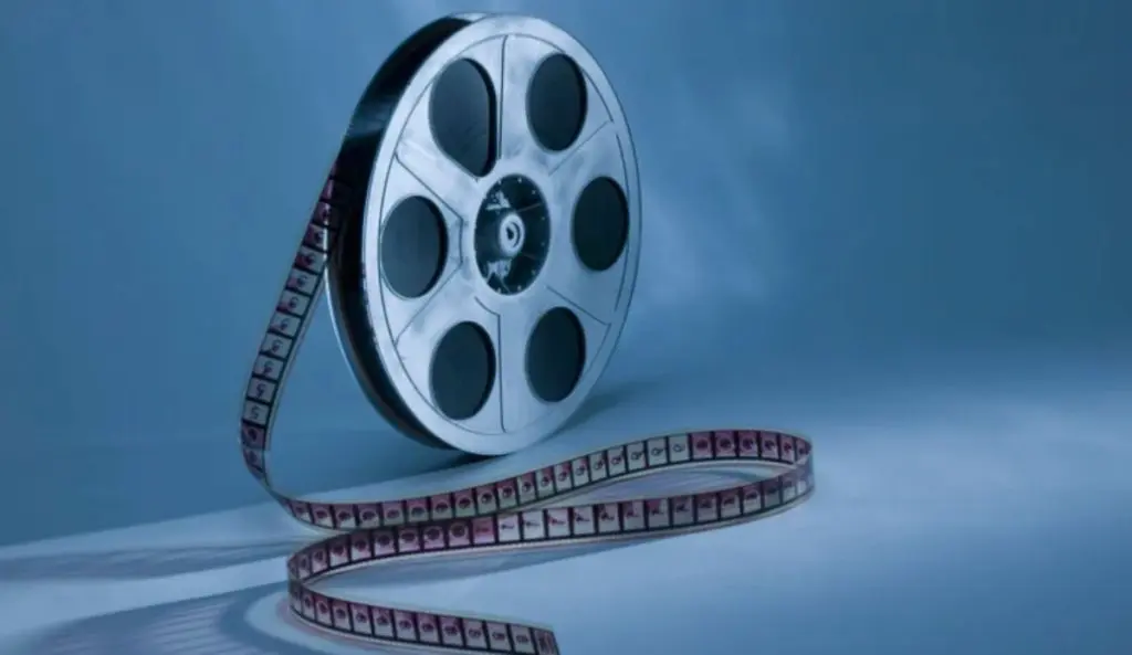 Ilustración de una bobina metálica con película extendida sobre fondo azul.